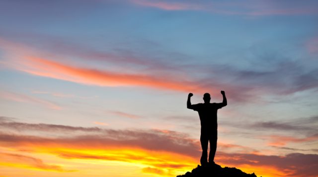 Silhouette of a Strong Man With Biceps Pumped