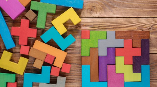 Logical tasks composed of colorful wooden shapes. Visual conundrum. Concept of creative, logical thinking or problem solving. Business concept, rational solution.