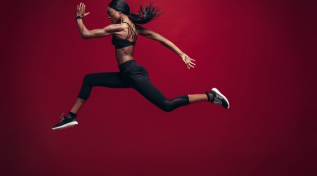 Female athlete running and jumping