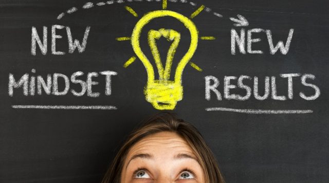 Photo of a person's head with a light bulb drawn above it. The words "new mindset, new results" are written next to the light bulb